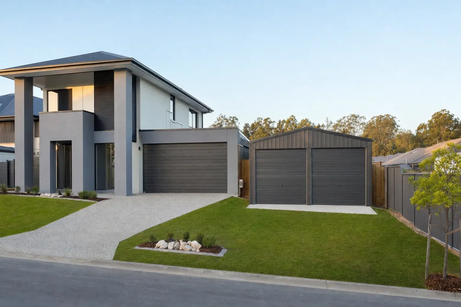 Charcoal double garage shed beside a new two-storey home on a flat Pimpama estate lot